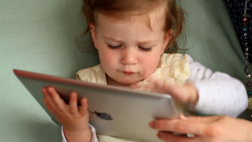 Child playing with iPad